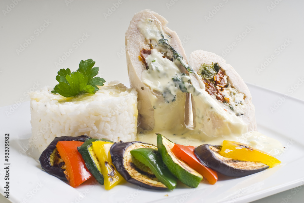 Turkey rolls with gorgonzola cheese, dried tomatoes and spinach stuffing with grilled vegetables and rice