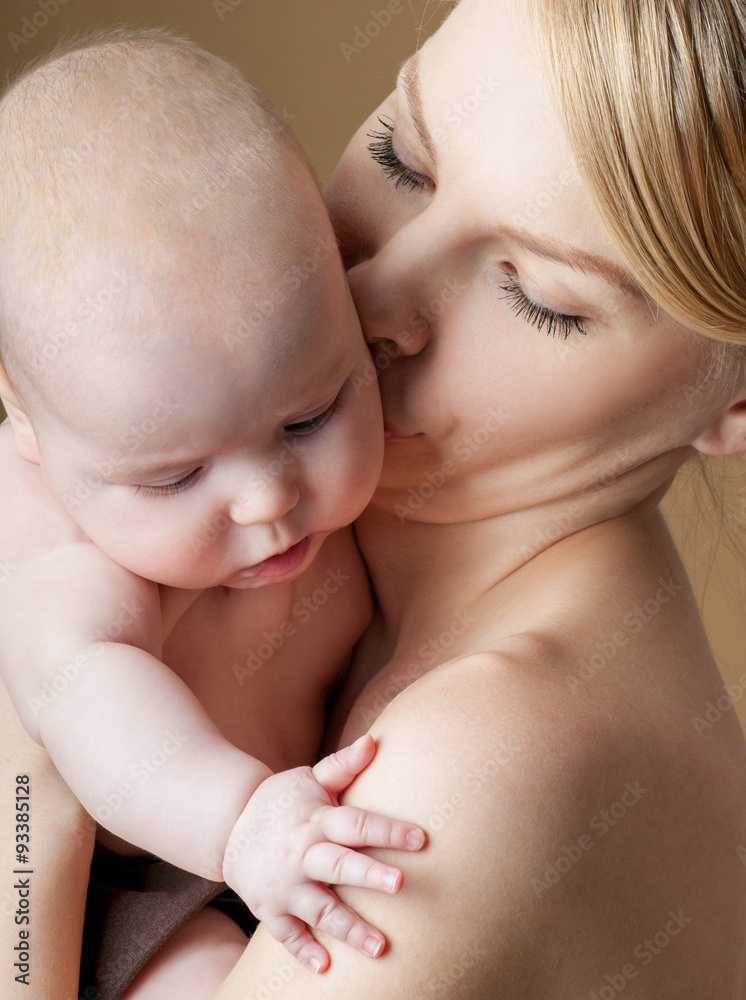 Young mother with a charming baby.Happy family. Mom's love and t Young mother with a charming baby.Happy family. Mom's love and t