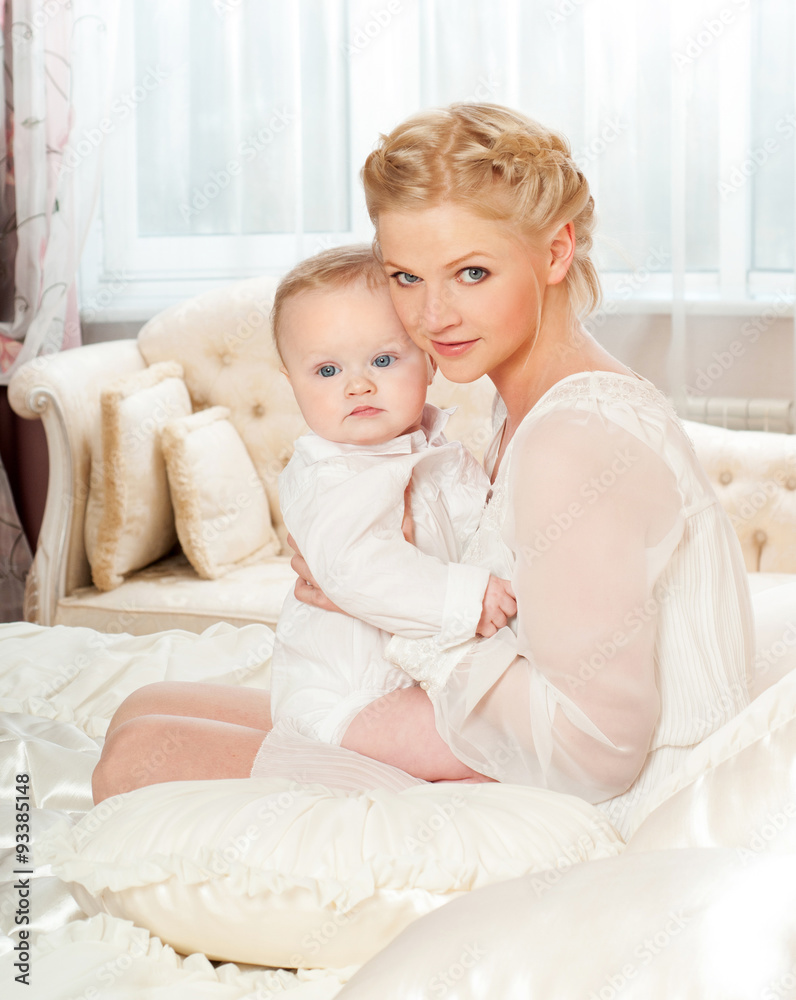 Mother and baby playing and smiling. Happy family.Home interior.