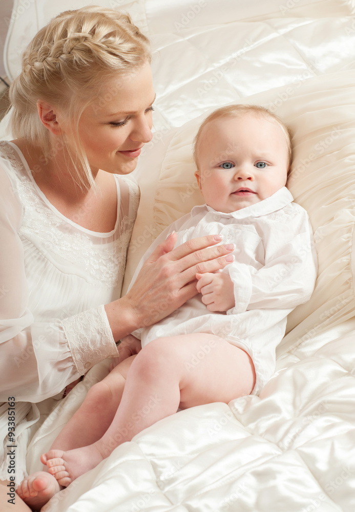 Mother and baby playing and smiling. Happy family.Home interior. Mother and baby playing and smiling. Happy family.Home interior.