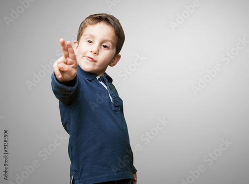 little kid doing victory sign