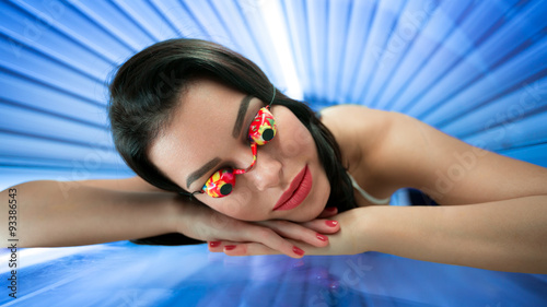 Girl with protect glasses in solarium