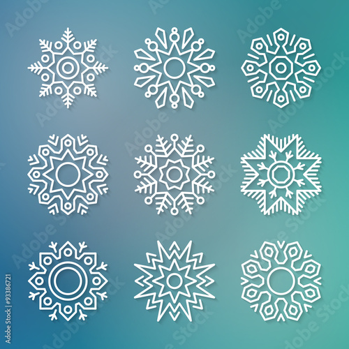 Set of flat line vector paper snowflakes with shadows on blue blurred background. Christmas and New Year decoration element. Simple shape template for graphic design