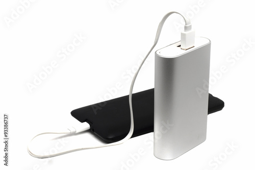dusty mobile phone and an external battery on a white background