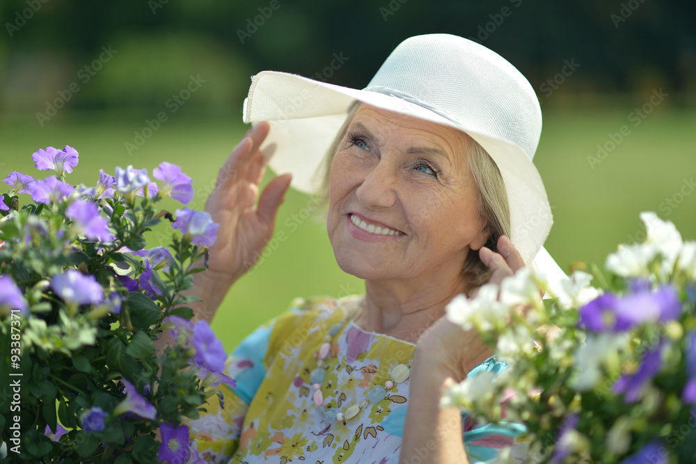 Fototapeta premium Older woman with flowers