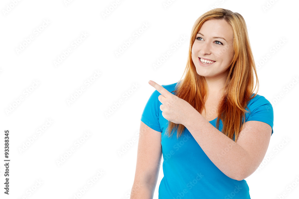 Smiling lady looking and pointing away Smiling lady looking and pointing away