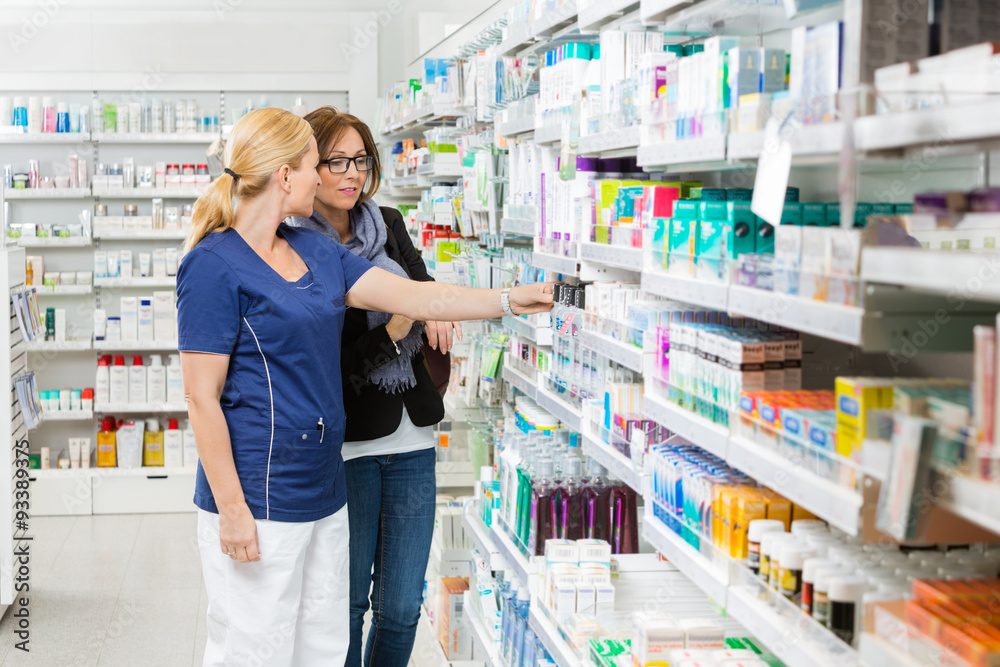Pharmacist Removing Product For Customer From Shelf