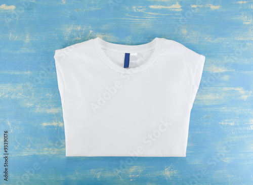 White t-shirt template on a blue wooden background. photo