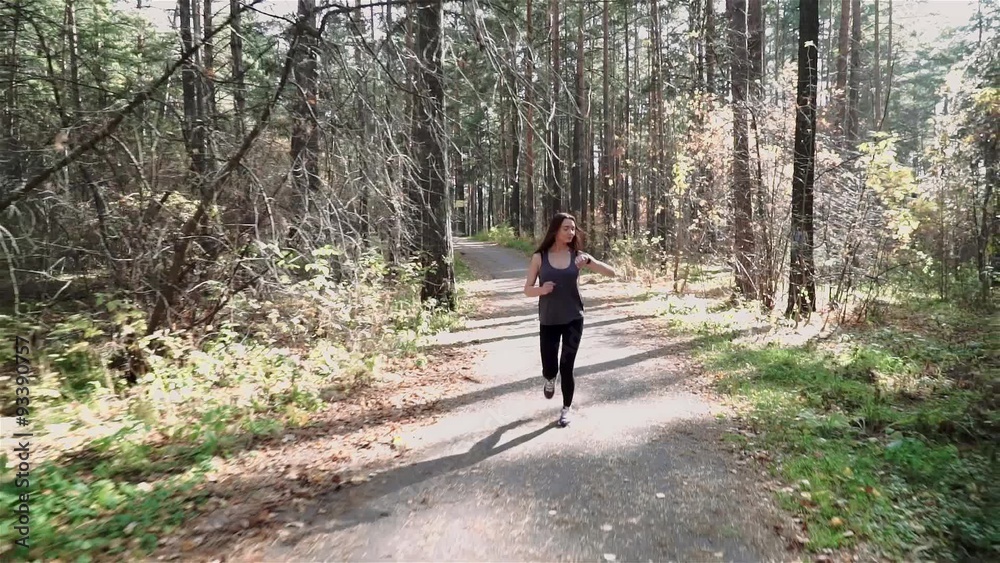 woman jogging in the morning and looking at smart watches woman jogging in the morning and looking at smart watches