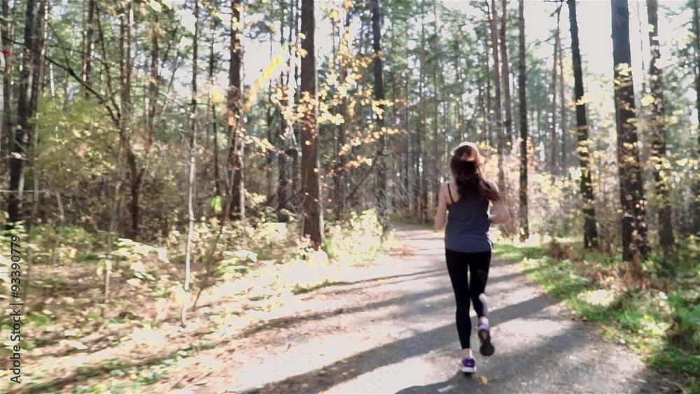 woman jogging in the morning and looking at smart watches woman jogging in the morning and looking at smart watches