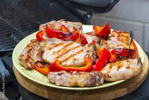 Grilled meat with sweet paprika on a dish.

