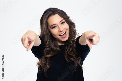 Portrait of a cheerful woman pointing at camera