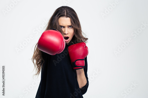 Woman in boxing gloves hitting at camer