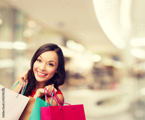 smiling young woman with shopping bags