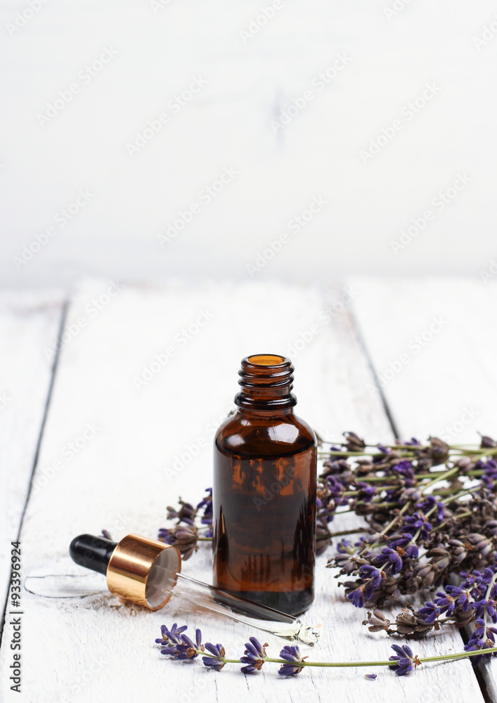 Dry lavender and oil on a white wooden table Dry lavender and oil on a white wooden table