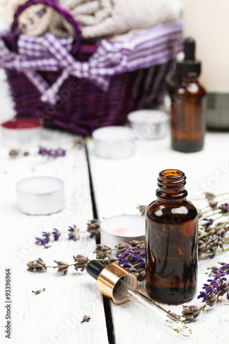 Fototapeta Naklejka Na Ścianę i Meble -  Dry lavender and oil  on a white wooden table