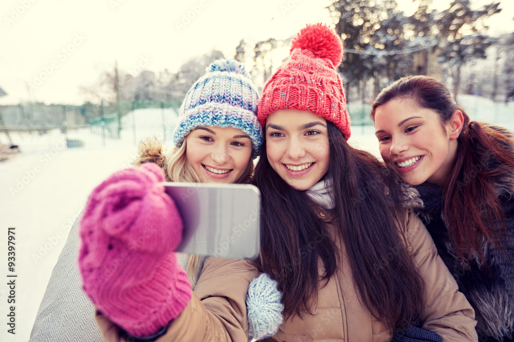 happy teenage girls taking selfie with smartphone