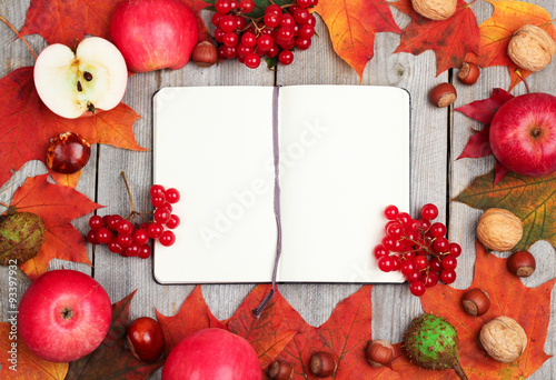 Autumn leaves and harvest on a wooden background