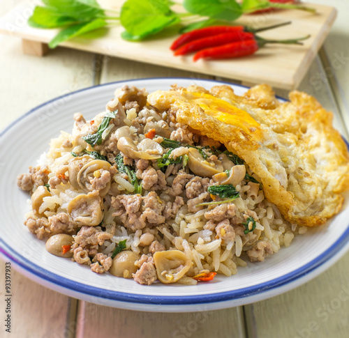 pork fried rice and fried egg with basil and chili background