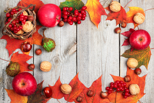Autumn leaves and harvest on a wooden background
