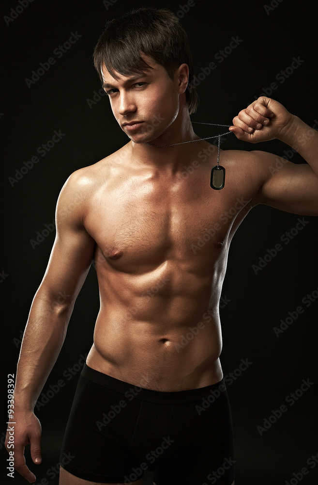The muscular young sexy man on black background The muscular young sexy man on black background
