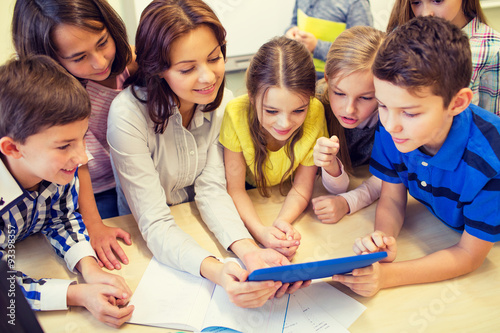 Konstfotografi group of kids with teacher and tablet pc at school