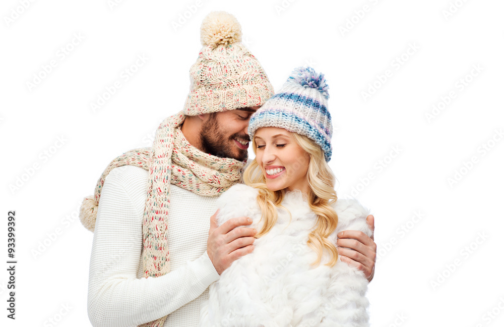 smiling couple in winter clothes hugging smiling couple in winter clothes hugging