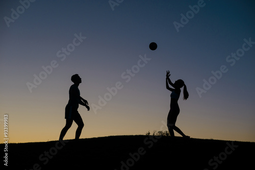Boy and girl playing volleyball on the weekend.