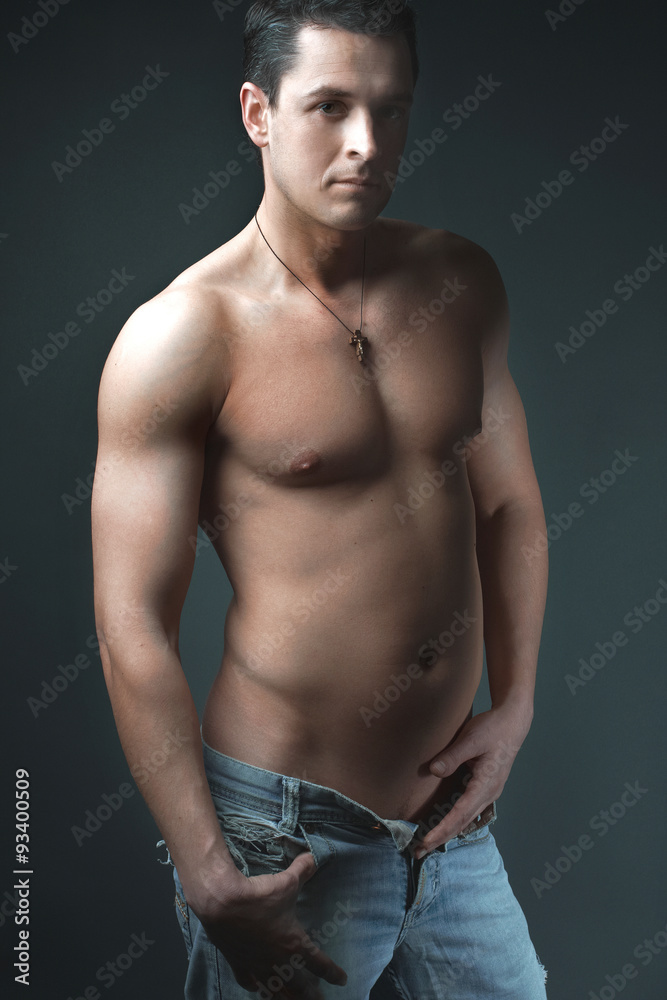 strong athletic man on black background