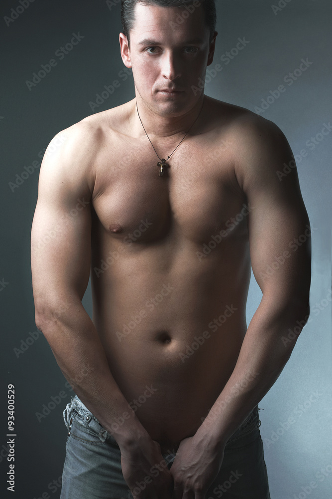 Fototapeta premium strong athletic man on black background