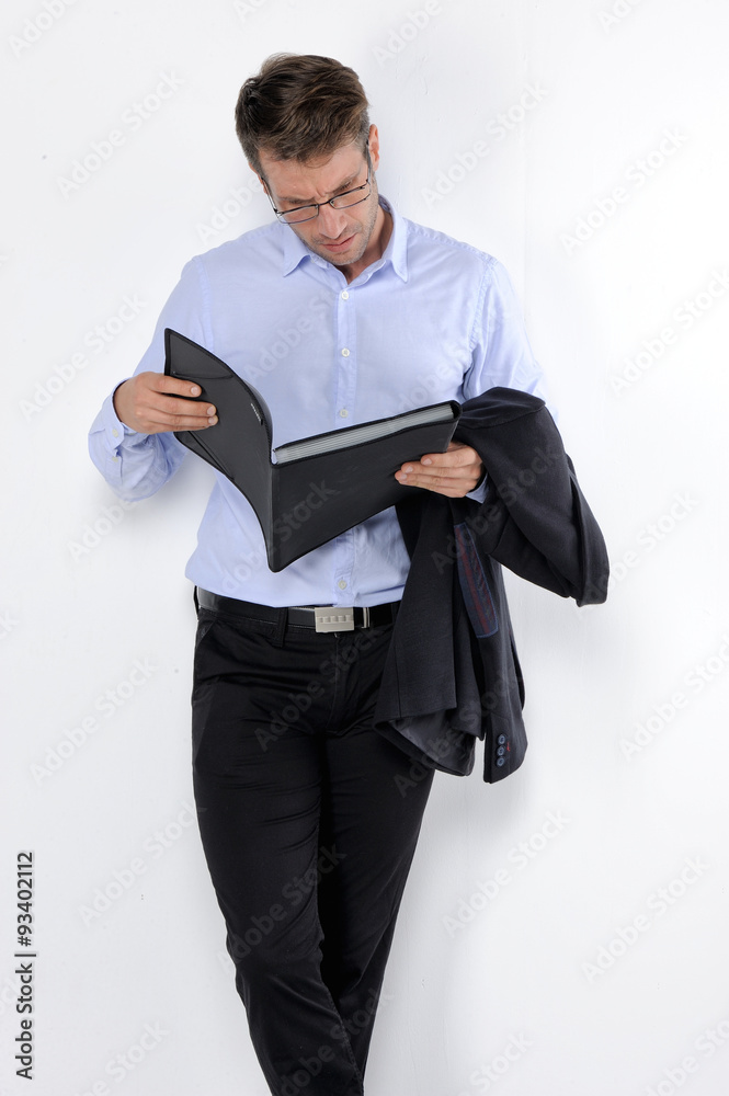 Young handsome man in black suit and glasses smiling isolated on white background.. Young handsome man in black suit and glasses smiling isolated on white background..