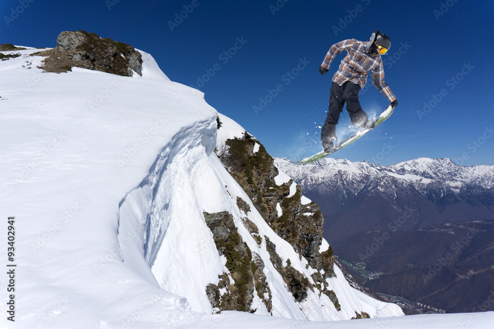 Flying snowboarder on mountains Flying snowboarder on mountains