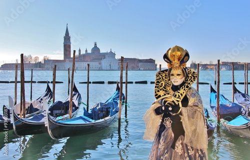 Woman wearing a beautiful golden costume in Venice 