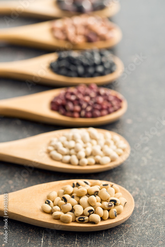 various legumes in wooden spoons