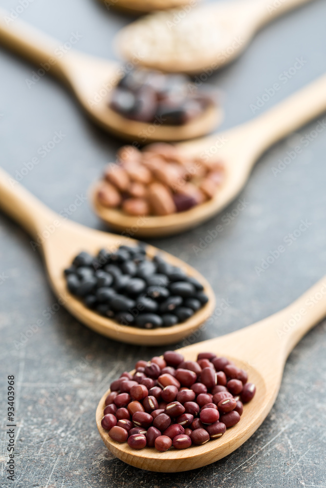 various legumes in wooden spoons various legumes in wooden spoons