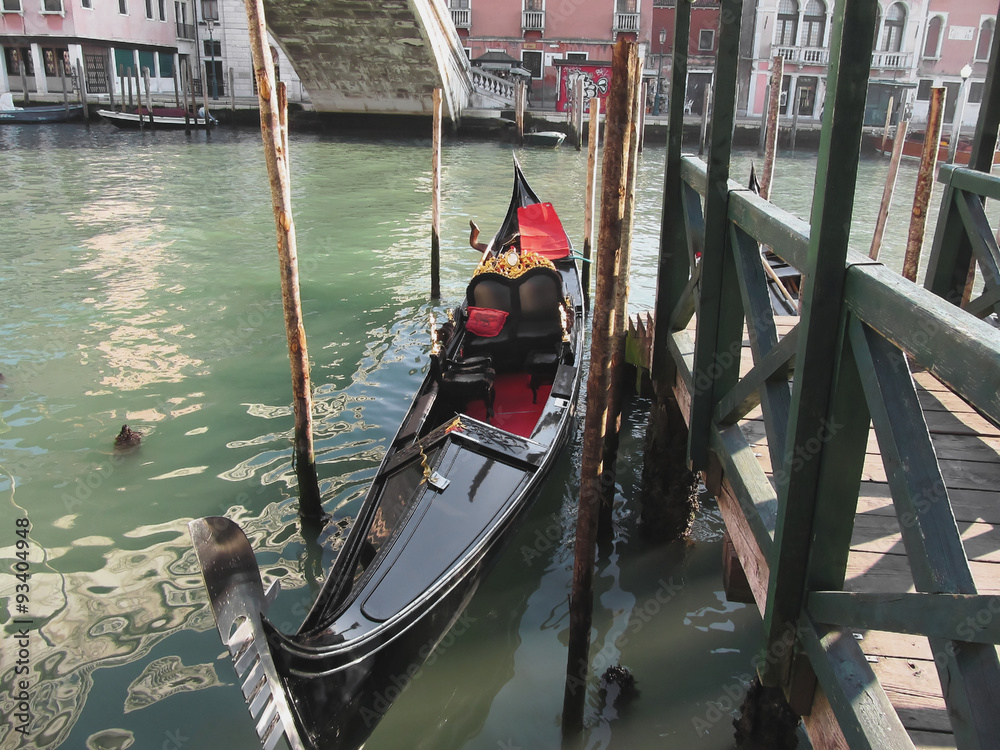Gondola moored by quay on Venice canal, Italy