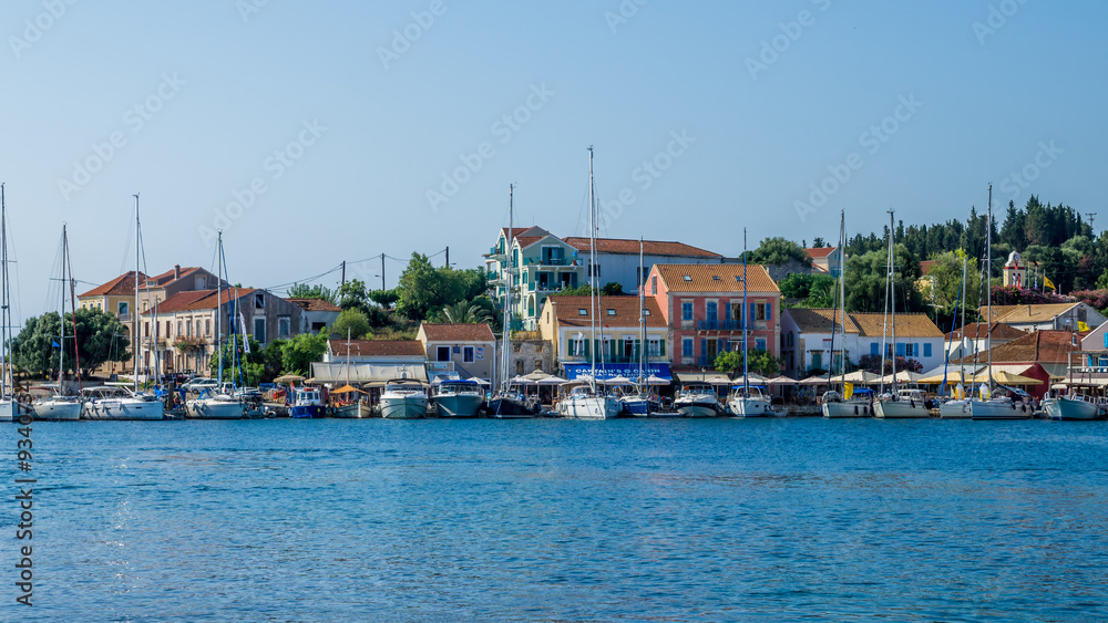 FISKARDO TOWN, KEFALONIA ISLAND, GREECE - JULY 12, 2015: Bay of Fiskardo with boats and yachts. Port of Fiskardo on Kefalonia island, Greece.