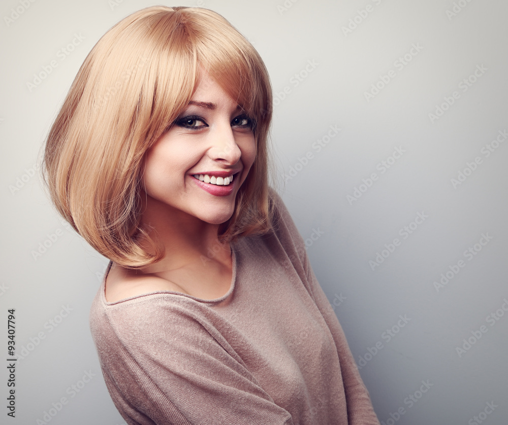 Happy toothy smiling young woman with short blond hair. Toned cl Happy toothy smiling young woman with short blond hair. Toned cl