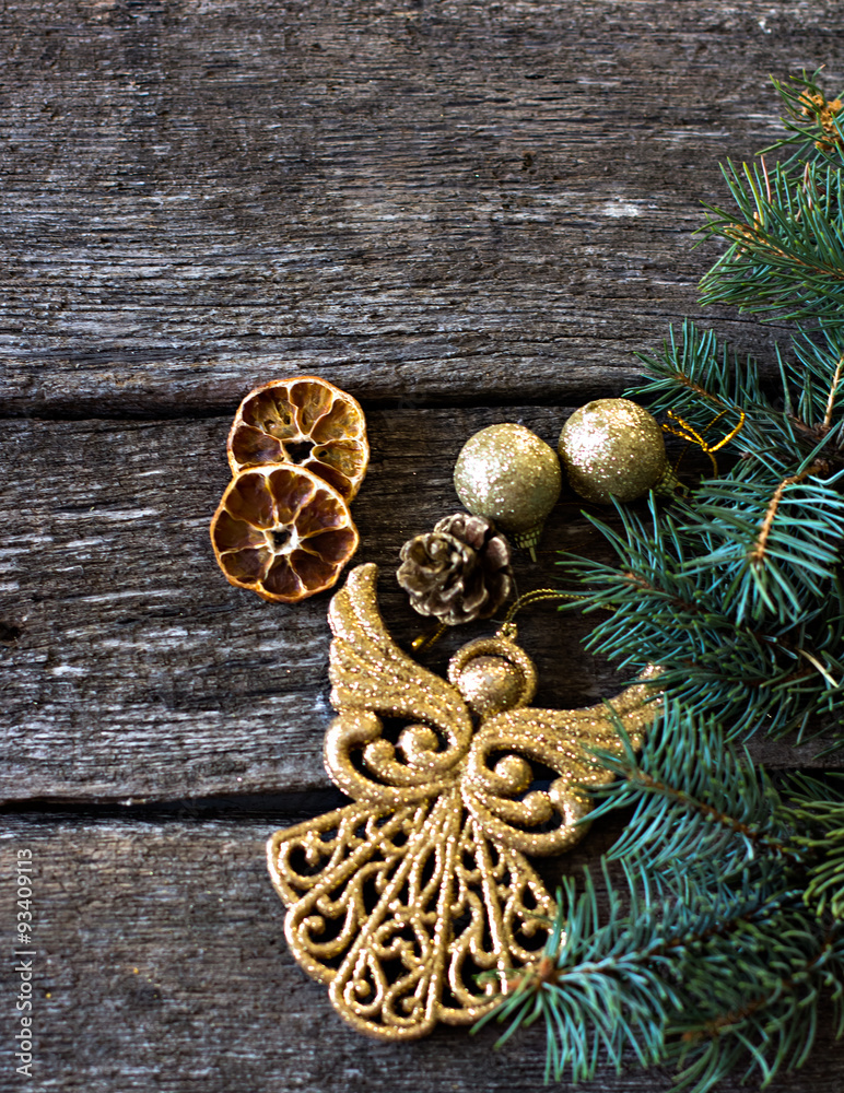 Christmas composition. Fir branches and Christmas decorations on a background of wooden boards. Toy Christmas Angel Christmas composition. Fir branches and Christmas decorations on a background of wooden boards. Toy Christmas Angel