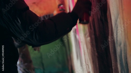 Writers painting graffiti in the night