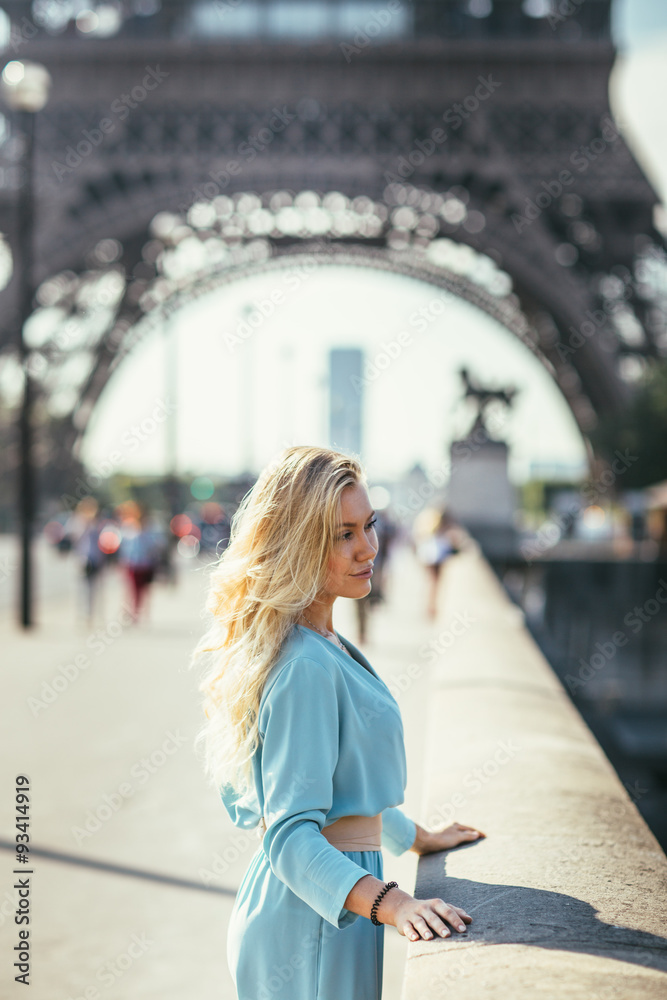 Beautiful young woman in Paris, near the Eiffel tower