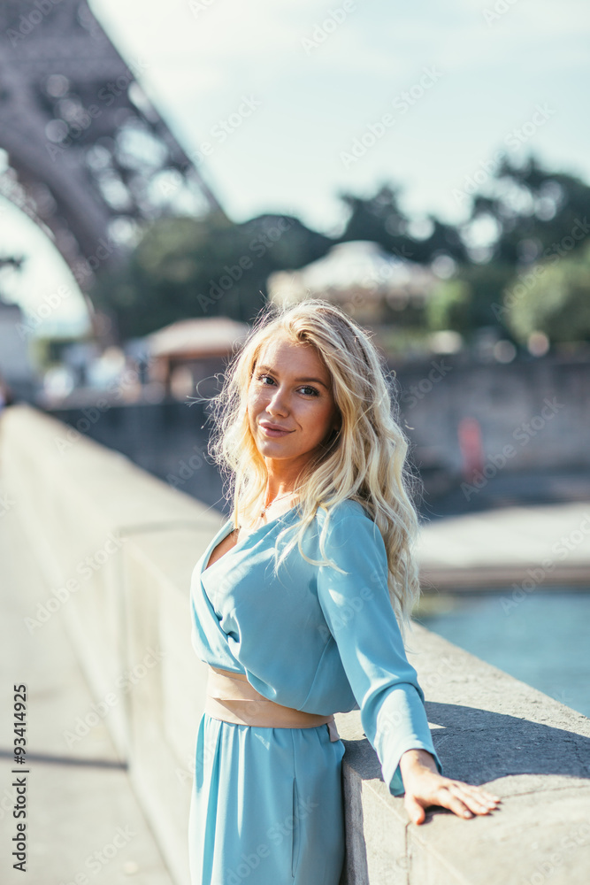 Beautiful young woman in Paris, near the Eiffel tower