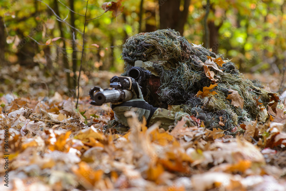 Camouflaged sniper lying in forest and aiming through his scope Stock Photo  by ©Nesterenko_Max 89112398