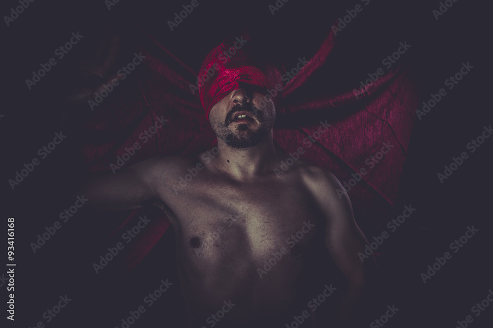 Horror, naked man on large red cloth over his eyes Horror, naked man on large red cloth over his eyes