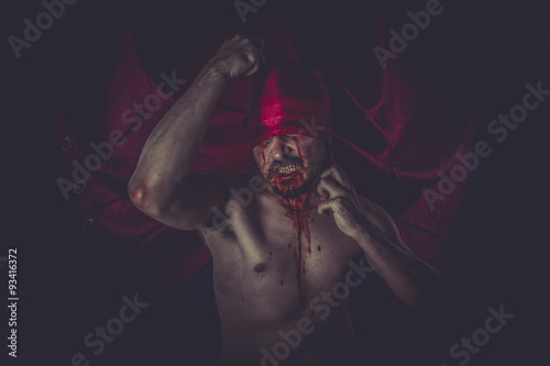 Fear, naked man on large red cloth over his eyes
