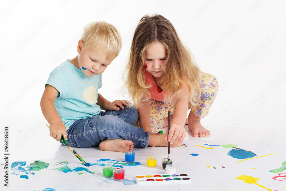 Childs are drawing pictures by aquarelle paints Childs are drawing pictures by aquarelle paints