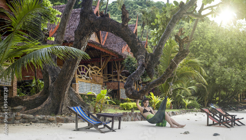 Young attractive girl on a hammock on a beach in Thailand