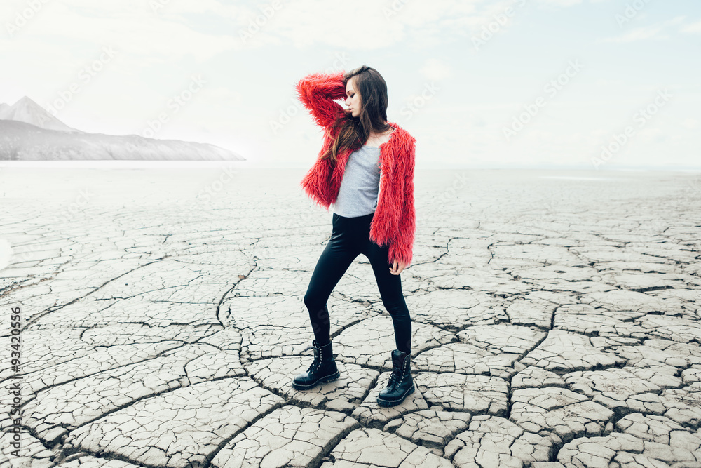 Young female model walking on dry land