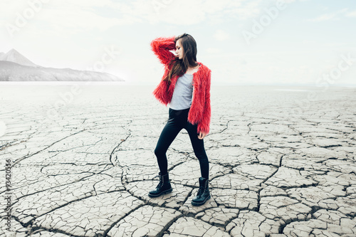 Young female model walking on dry land