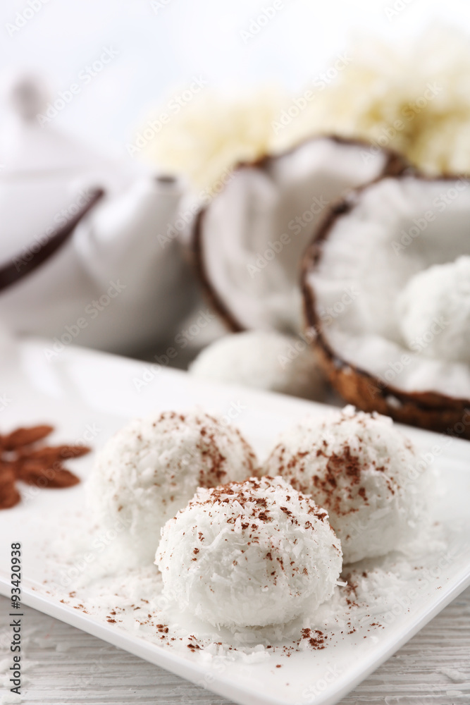 Homemade coco sweets on plate, on light background Homemade coco sweets on plate, on light background